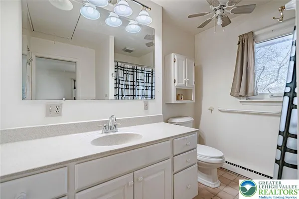 a room with stainless steel appliances kitchen island granite countertop a refrigerator and a stove