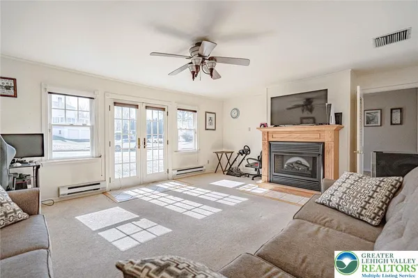 a living room with furniture a flat screen tv and a fireplace
