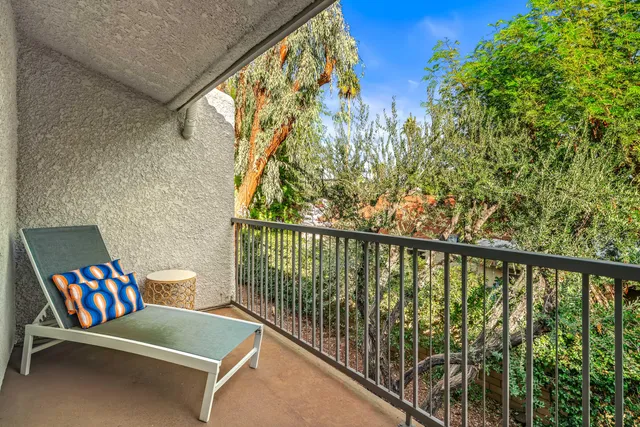 a view of a two chairs in the balcony
