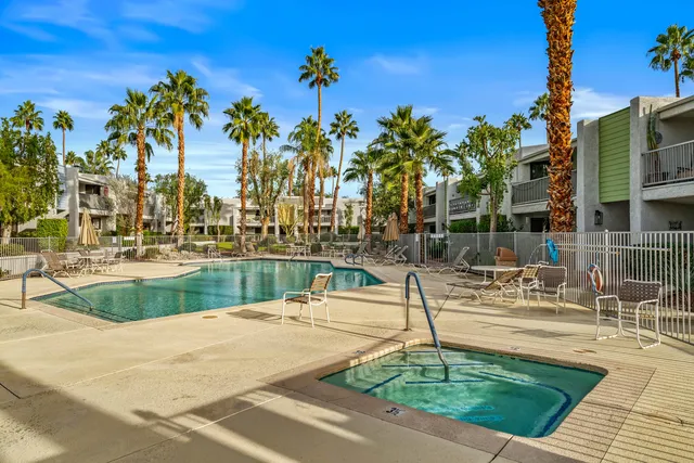 a swimming pool with outdoor seating and yard