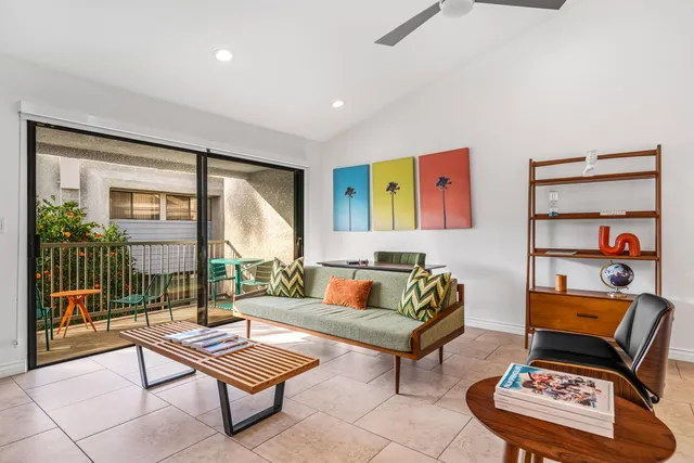 a living room with furniture and a potted plant
