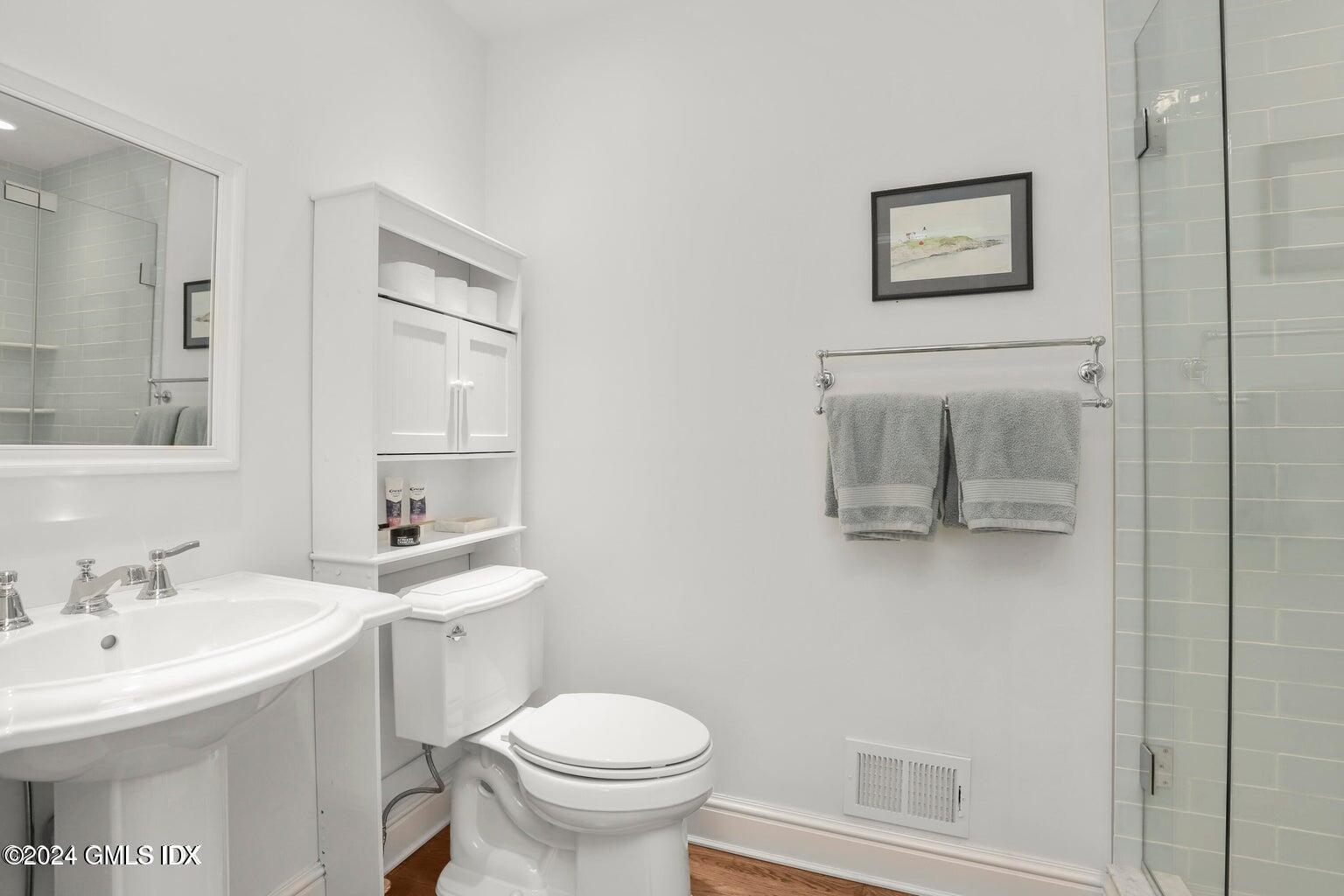 1 Old Church Road, Unit 1 Greenwich, CT 06830 - Photo 13 of 17 a bathroom with a toilet sink and mirror