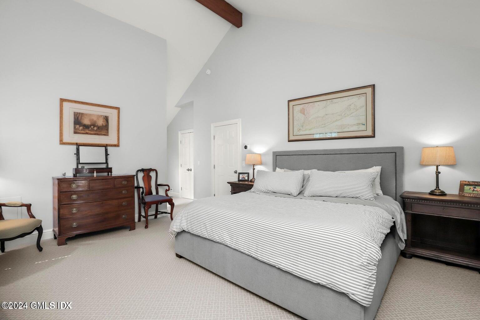 1 Old Church Road, Unit 1 Greenwich, CT 06830 - Photo 8 of 17 a bedroom with a bed painting on wall and a lamp on dresser