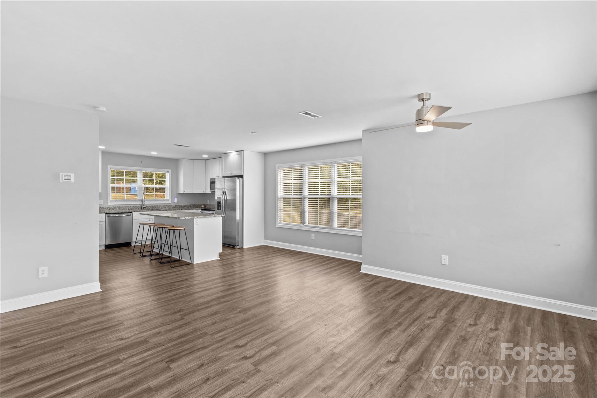 2518 Moose Road Kannapolis, NC 28083 - Photo 11 of 47 an empty room with wooden floor and windows
