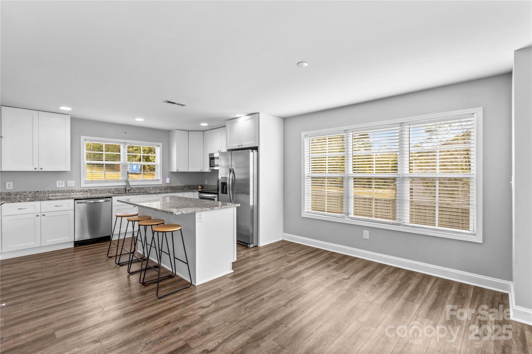 2518 Moose Road Kannapolis, NC 28083 - Photo 15 of 47 a kitchen with a sink wooden floor and windows