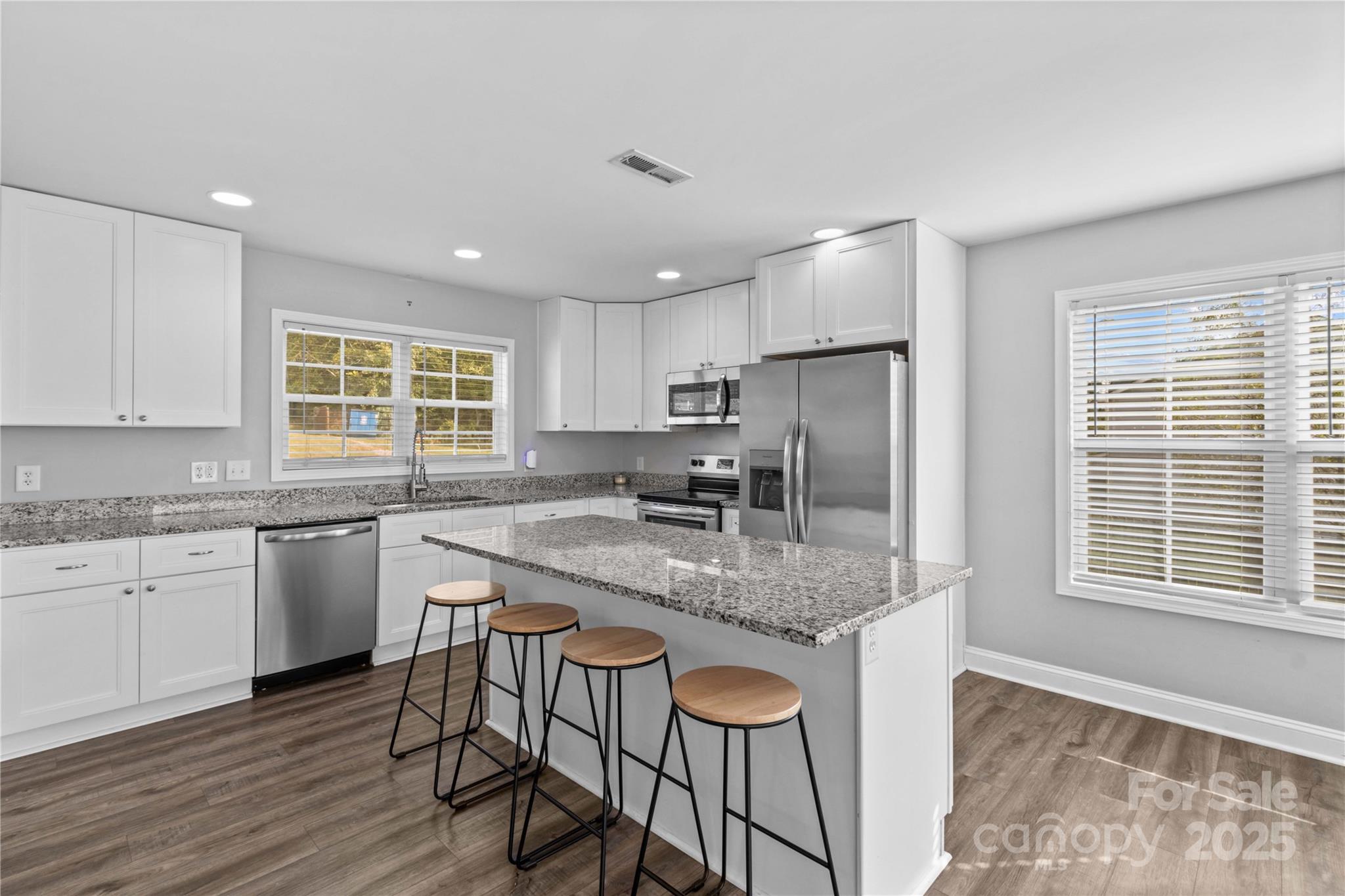 2518 Moose Road Kannapolis, NC 28083 - Photo 16 of 47 a kitchen with stainless steel appliances granite countertop a kitchen island hardwood floor sink stove and granite counter top
