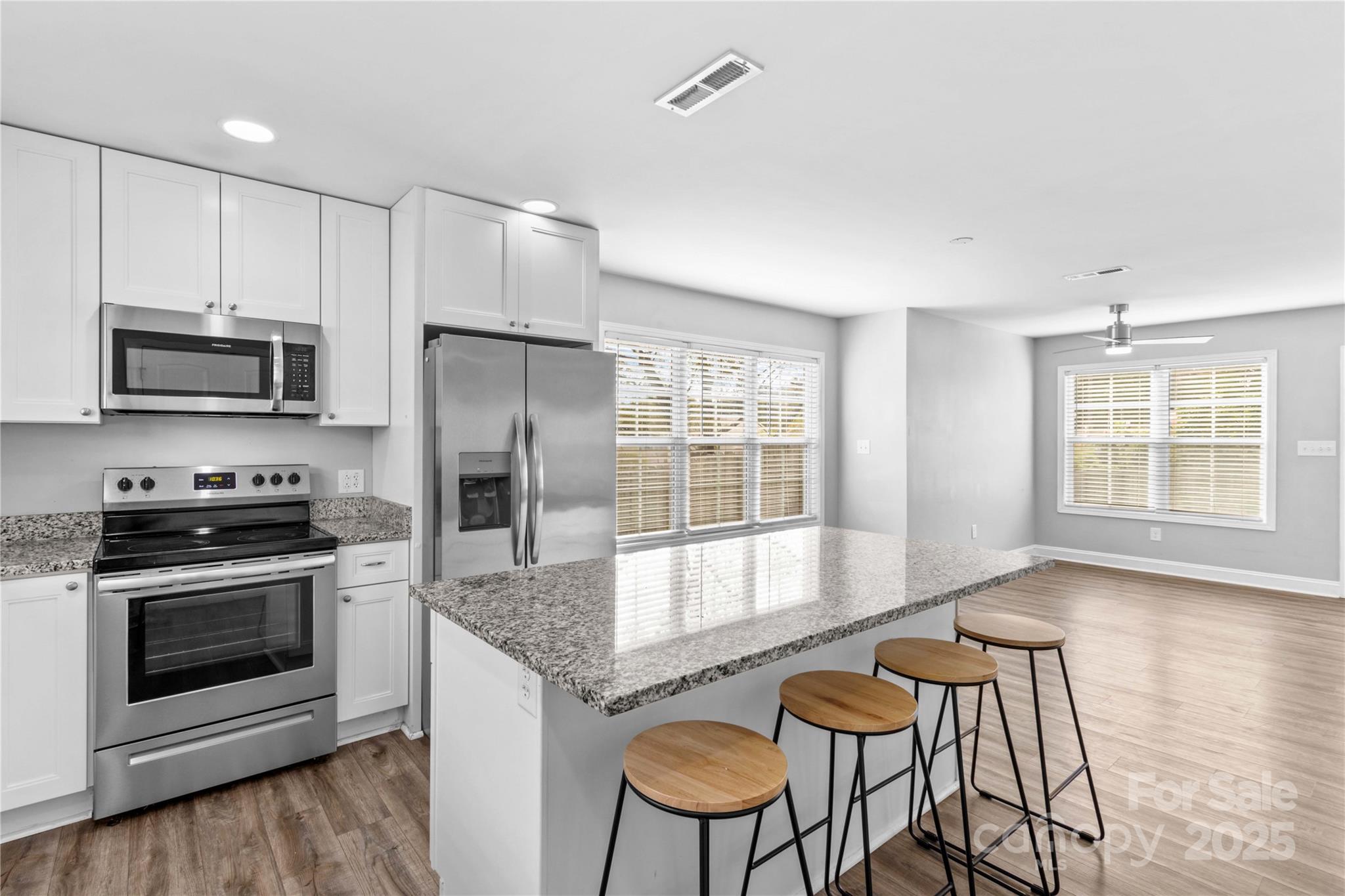 2518 Moose Road Kannapolis, NC 28083 - Photo 19 of 47 a kitchen with granite countertop a stove and a microwave