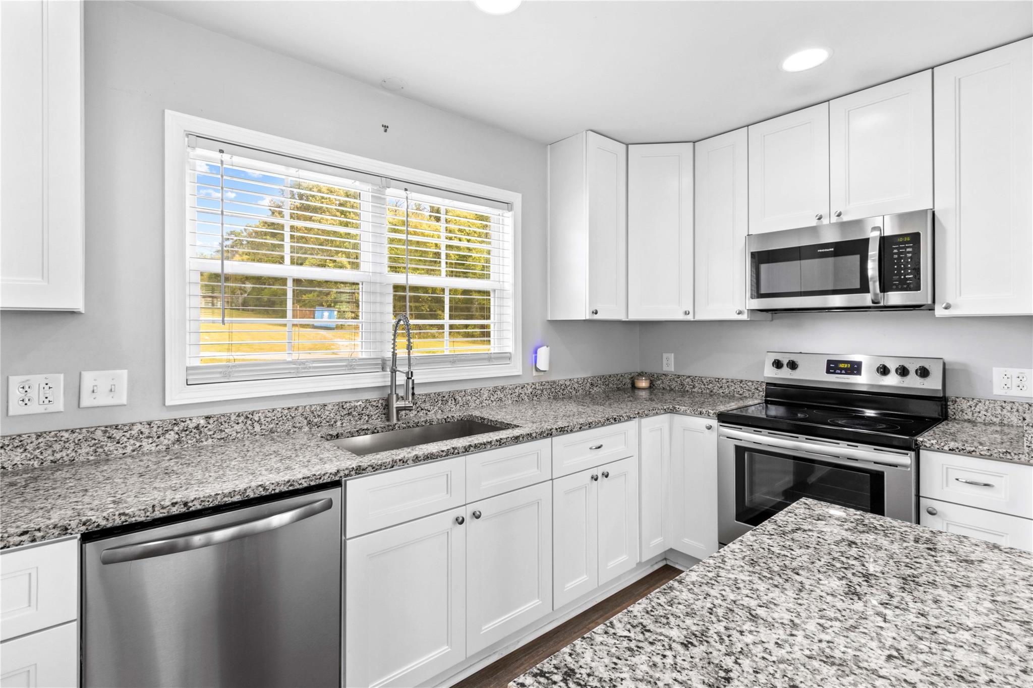 2518 Moose Road Kannapolis, NC 28083 - Photo 20 of 47 a kitchen with stainless steel appliances granite countertop a sink a stove a microwave and cabinets