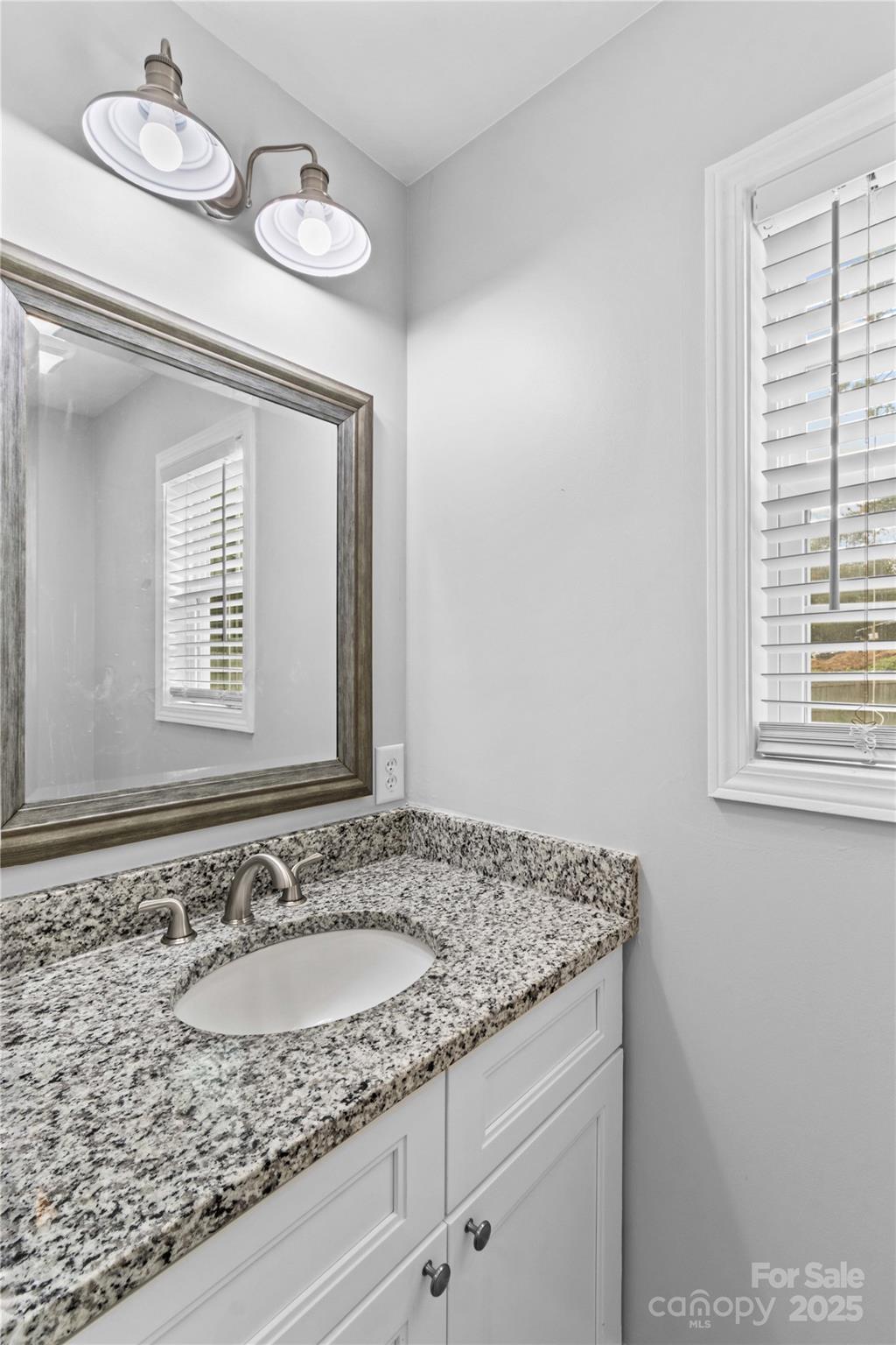 2518 Moose Road Kannapolis, NC 28083 - Photo 22 of 47 a bathroom with a granite countertop sink and a mirror