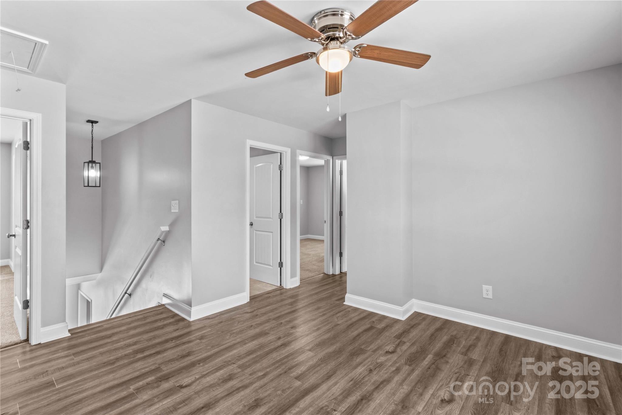 2518 Moose Road Kannapolis, NC 28083 - Photo 24 of 47 a view of an empty room with wooden floor and a ceiling fan