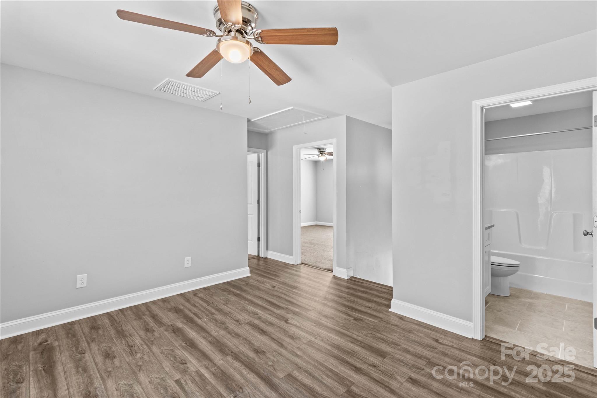 2518 Moose Road Kannapolis, NC 28083 - Photo 26 of 47 an empty room with wooden floor and a ceiling fan