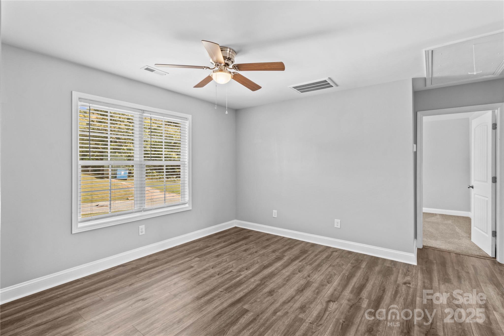 2518 Moose Road Kannapolis, NC 28083 - Photo 27 of 47 a view of an empty room with wooden floor and a window