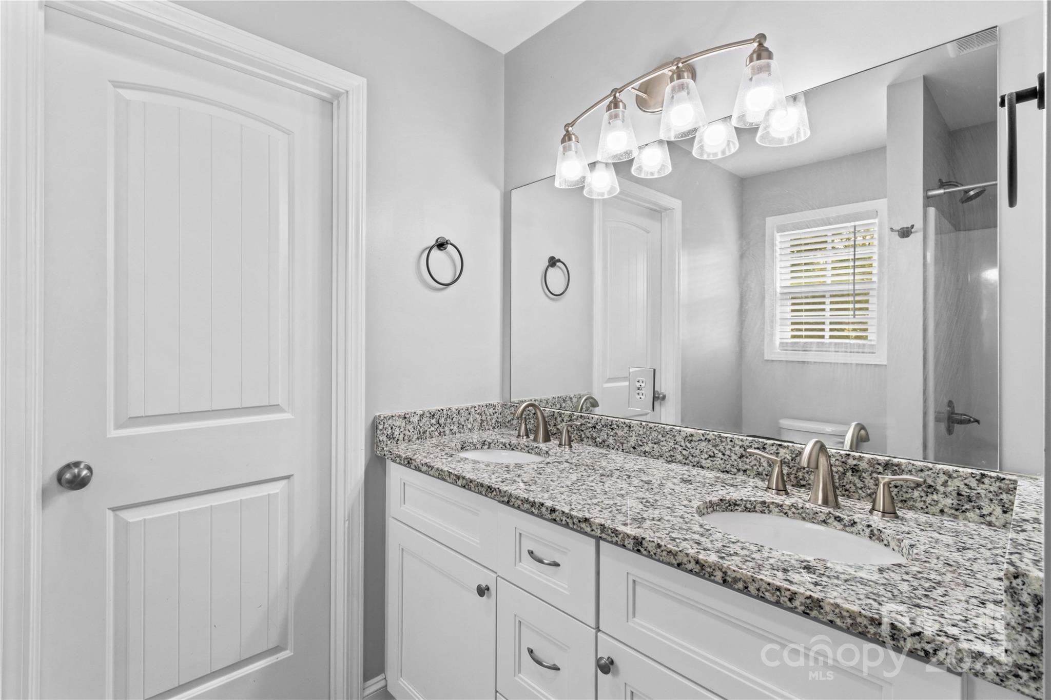 2518 Moose Road Kannapolis, NC 28083 - Photo 33 of 47 a bathroom with a granite countertop sink and a mirror