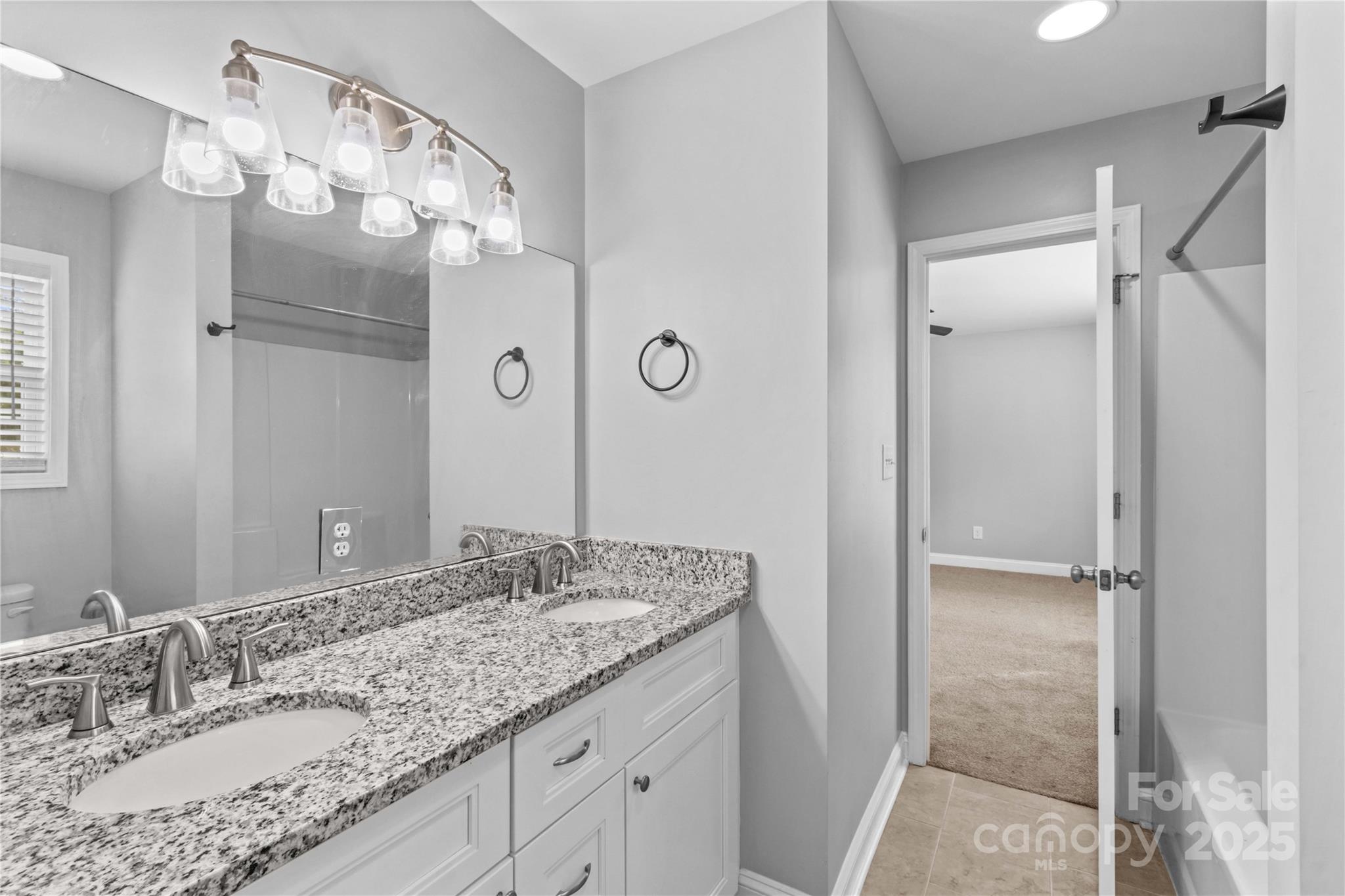 2518 Moose Road Kannapolis, NC 28083 - Photo 34 of 47 a bathroom with a granite countertop sink a mirror and shower