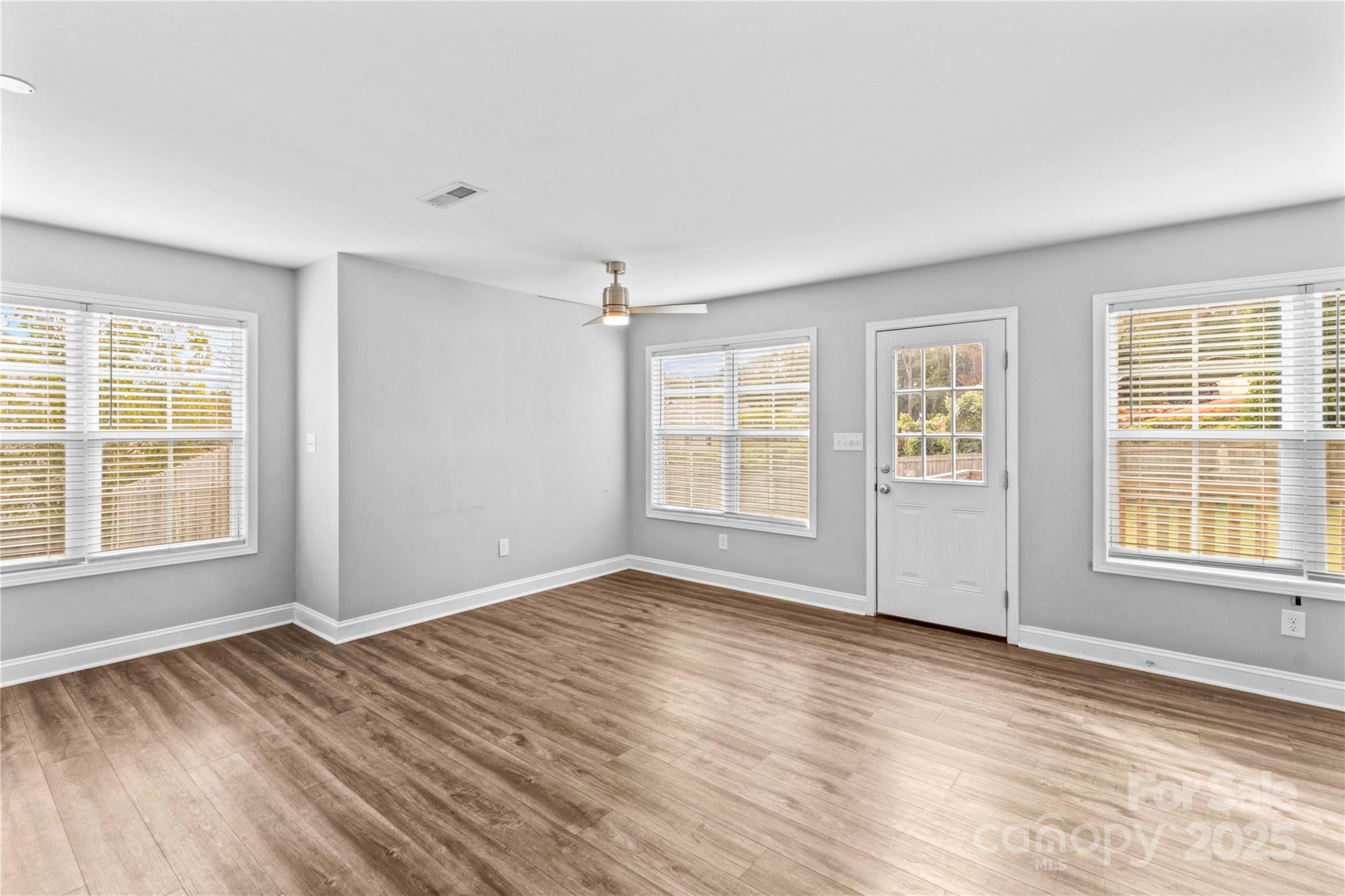 2518 Moose Road Kannapolis, NC 28083 - Photo 6 of 47 an empty room with wooden floor and windows