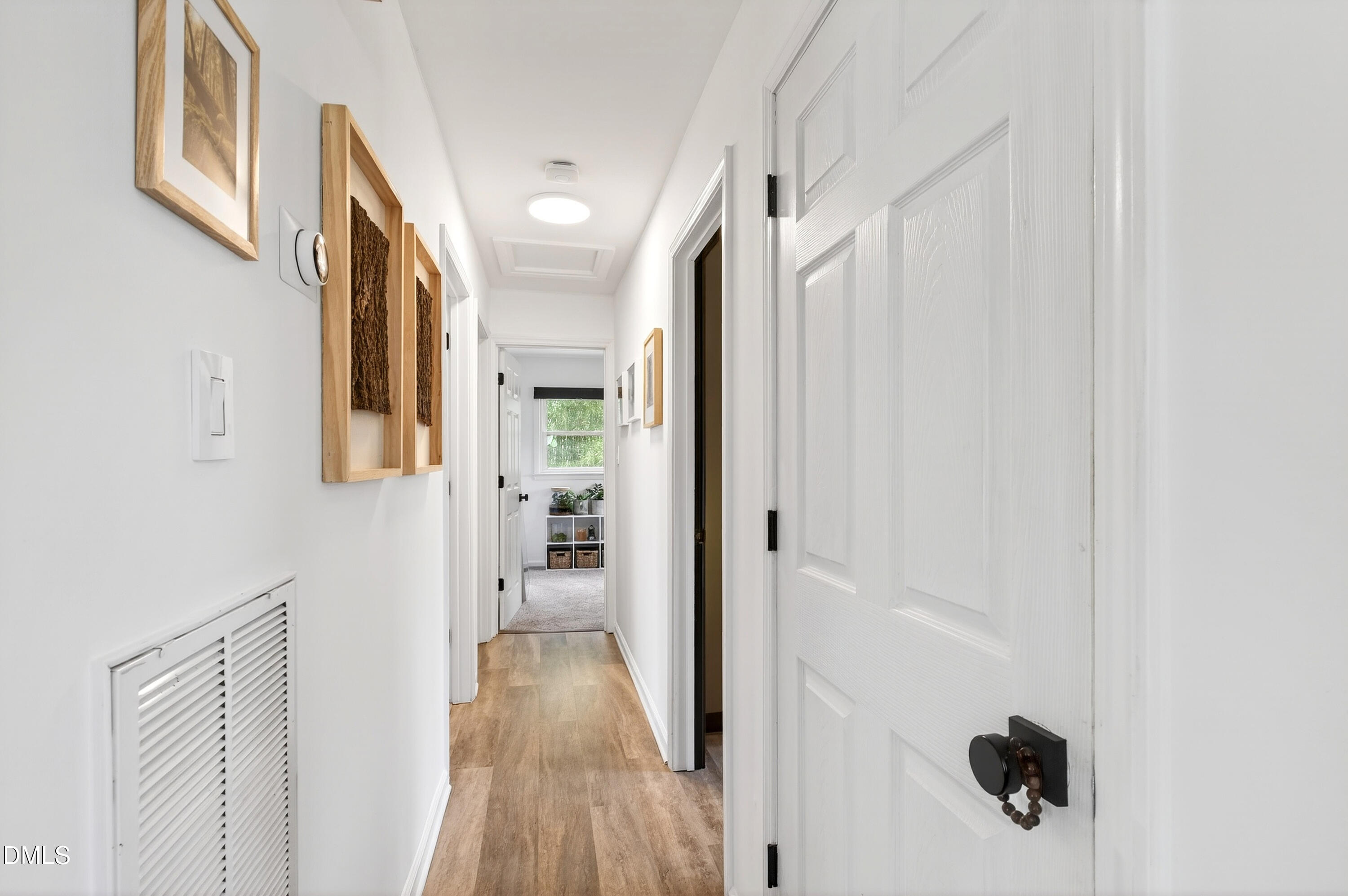 917 Carlisle Street Raleigh, NC 27610 - Photo 14 of 33 a view of a hallway with wooden floor and staircase