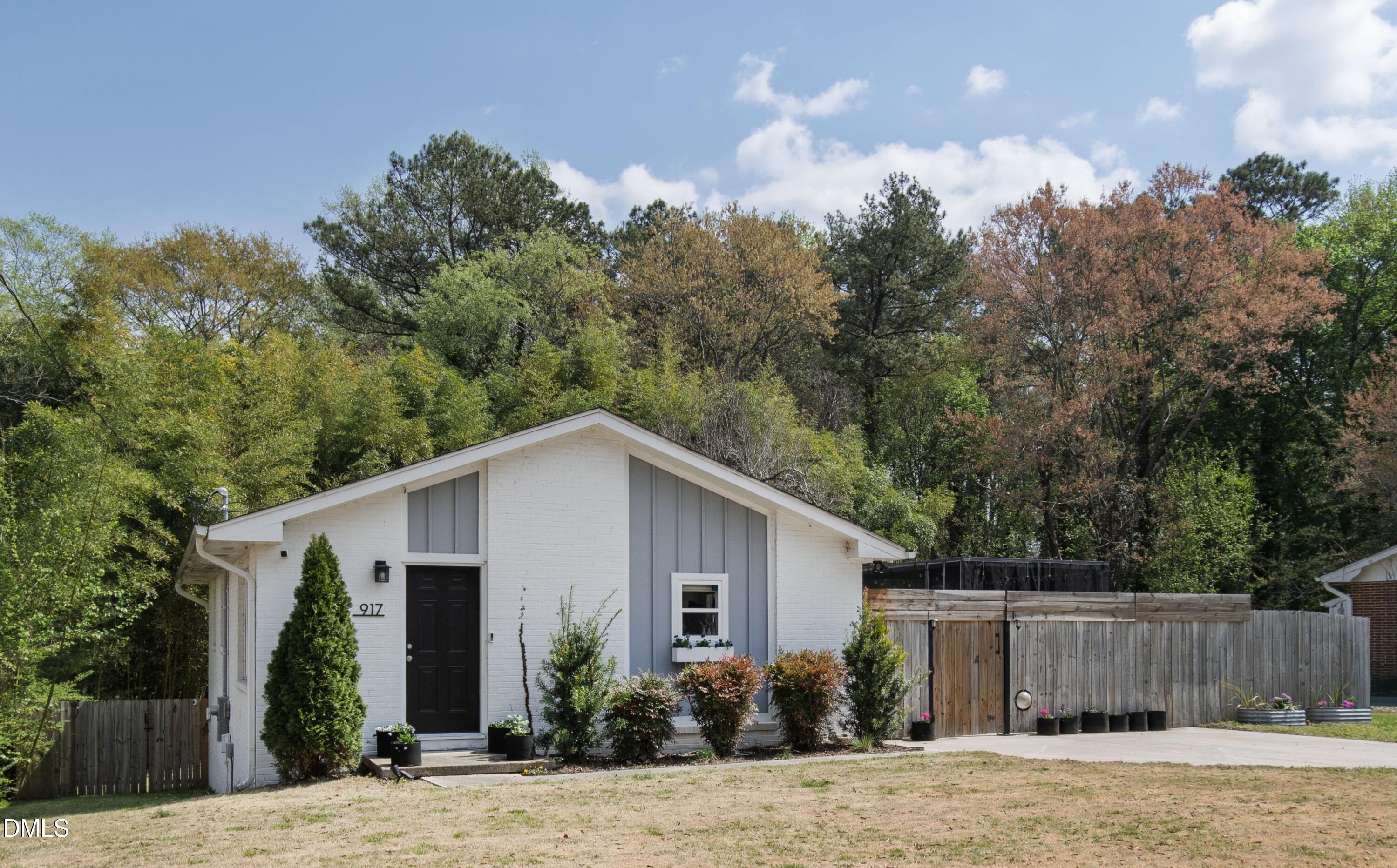 917 Carlisle Street Raleigh, NC 27610 - Photo 2 of 33 a view of a house with a yard and potted plants