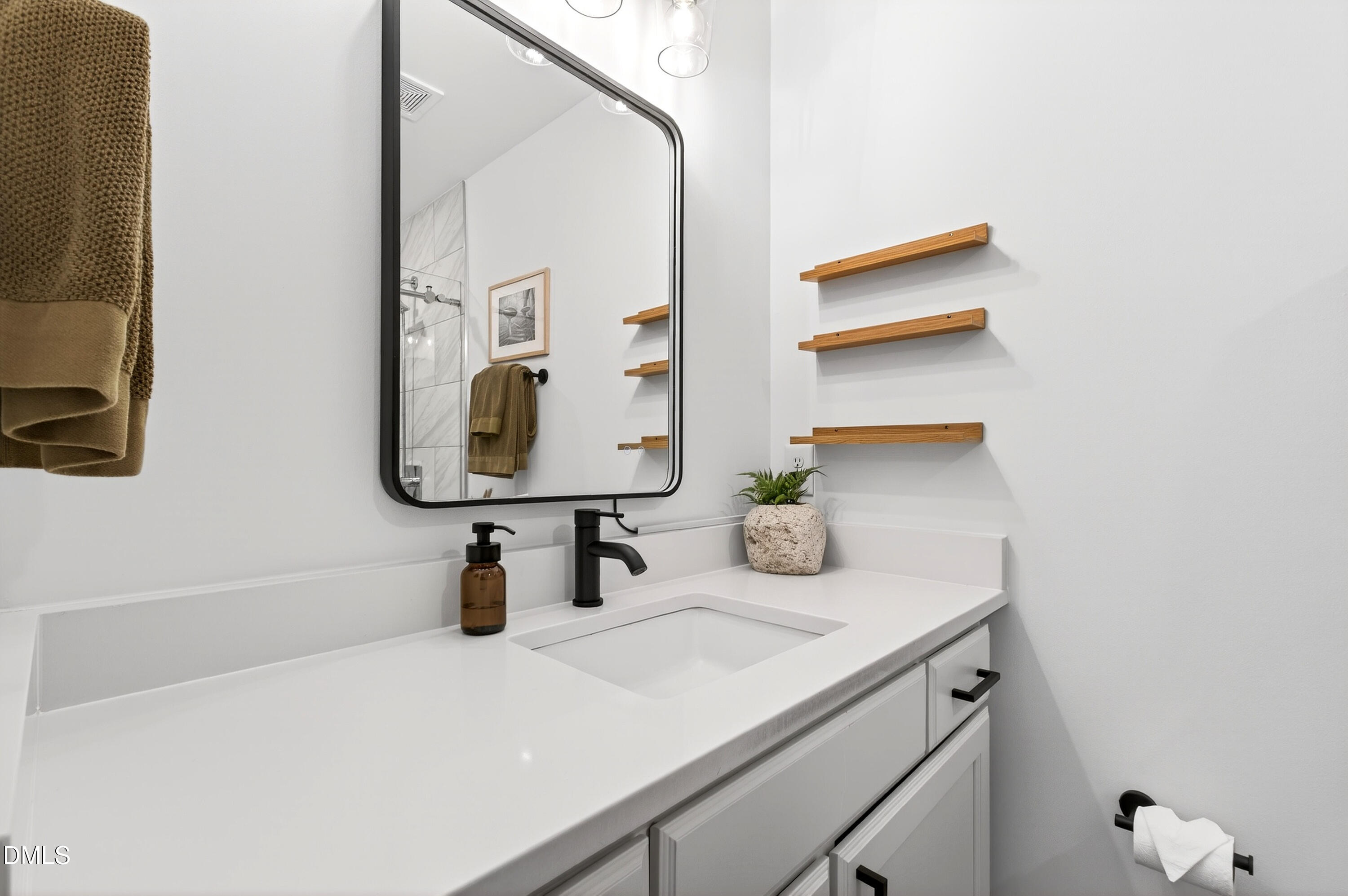 917 Carlisle Street Raleigh, NC 27610 - Photo 24 of 33 a bathroom with a sink and a mirror