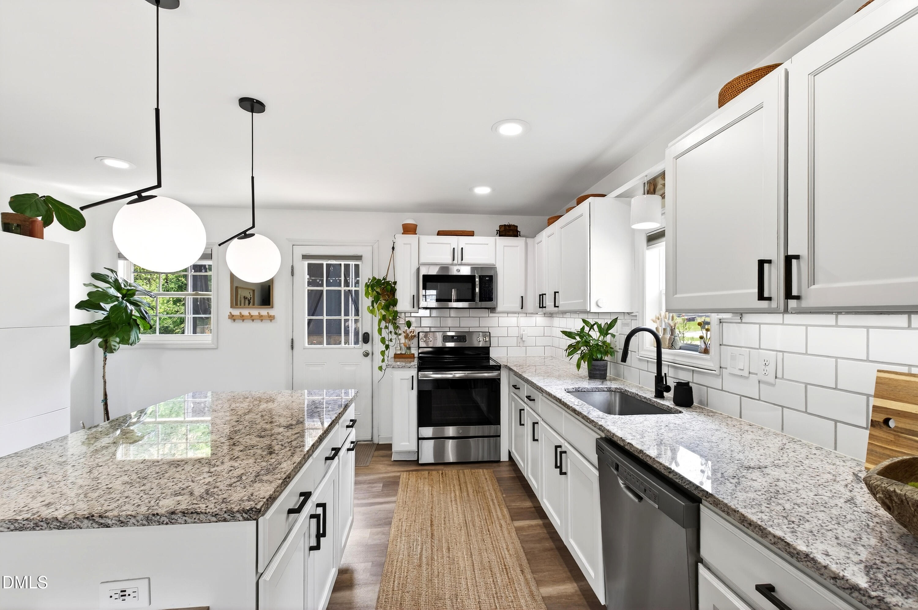 917 Carlisle Street Raleigh, NC 27610 - Photo 6 of 33 a kitchen with stainless steel appliances granite countertop a sink a stove top oven a counter space and cabinets