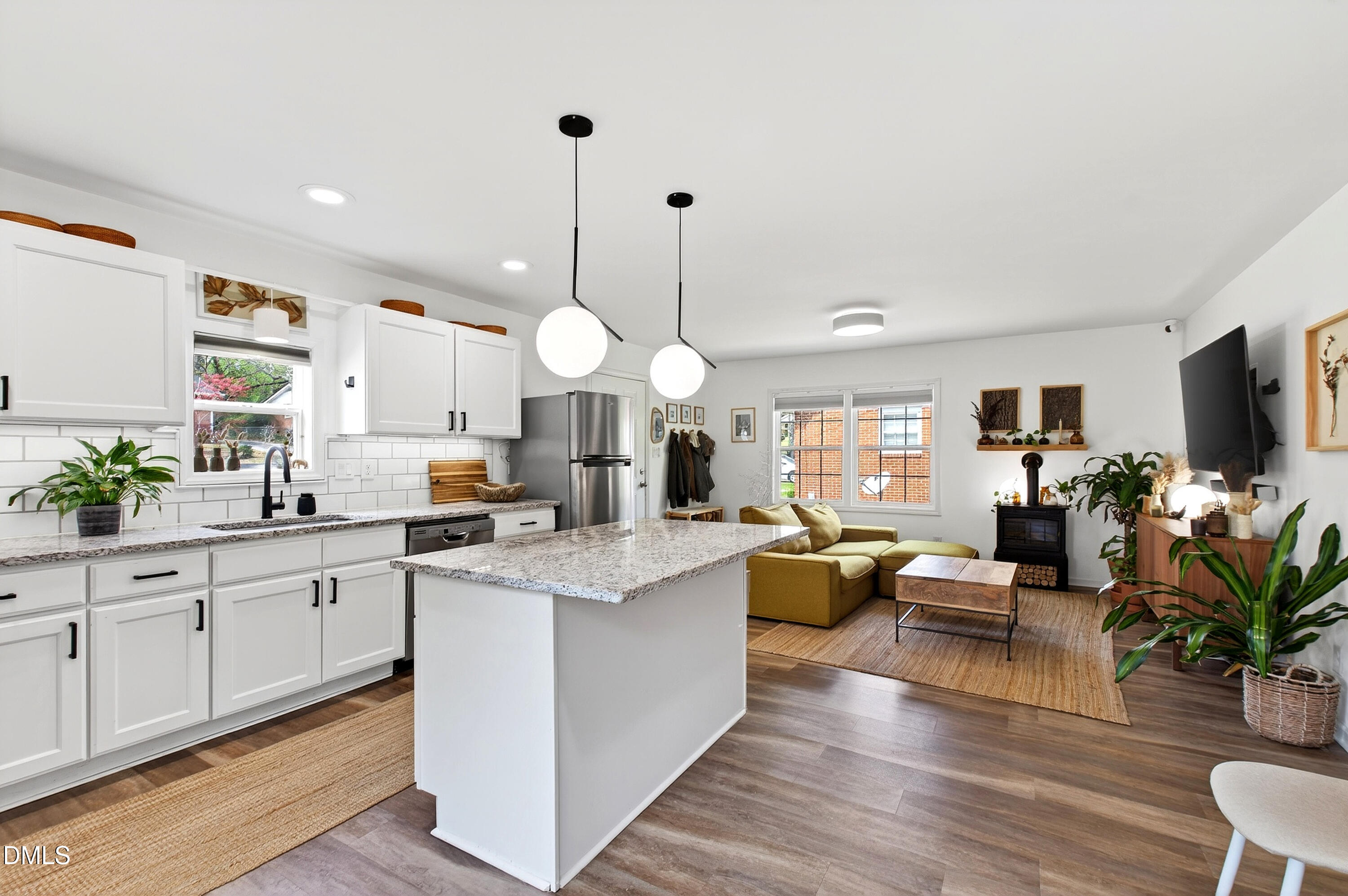 917 Carlisle Street Raleigh, NC 27610 - Photo 33 of 33 a large kitchen with lots of counter space dining table and stainless steel appliances