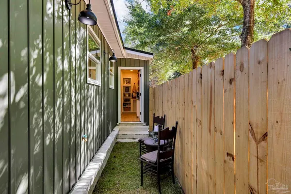 a view of a house with backyard and deck