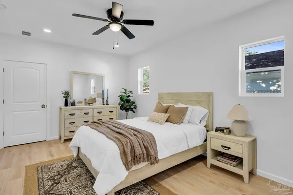 a bedroom with a bed and a chandelier