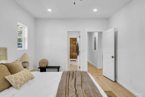a bedroom with a bed and wooden floor