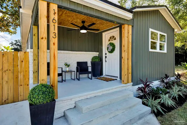 a view of a porch with potted plants