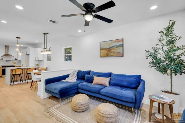 a living room with furniture and a potted plant