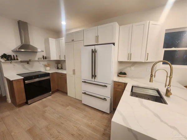 a kitchen with stainless steel appliances a stove sink and cabinets