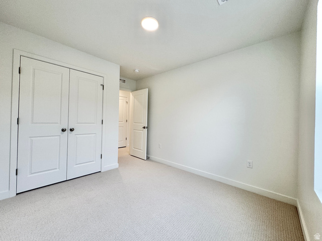 1650 North Main Street Layton, UT 84041 - Photo 13 of 24 Bright interior space featuring light-toned carpeting, white walls, and a matching baseboard trim