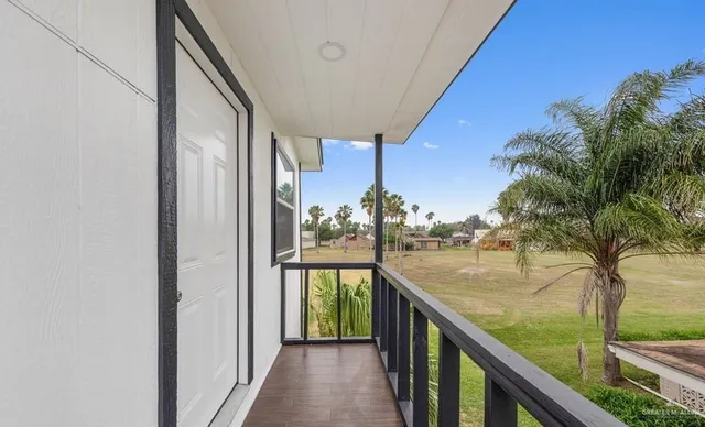 a view of balcony and yard