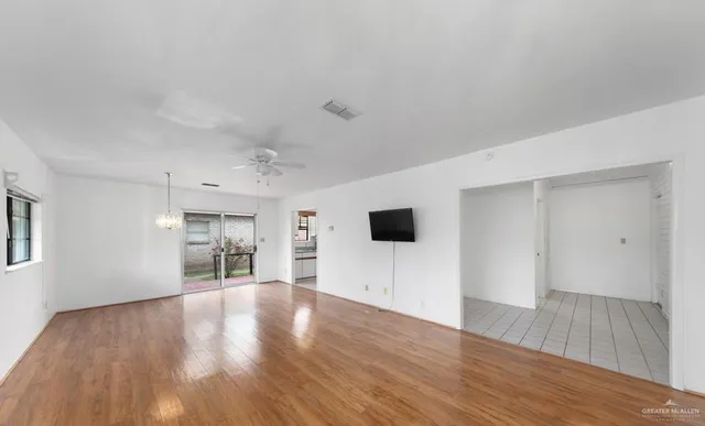 a view of a livingroom with wooden floor and a flat screen tv