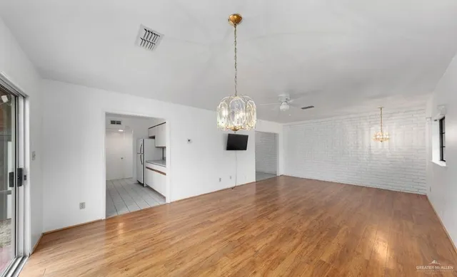 a view of a room with wooden floor