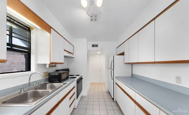 a kitchen with stainless steel appliances a sink a stove and a refrigerator
