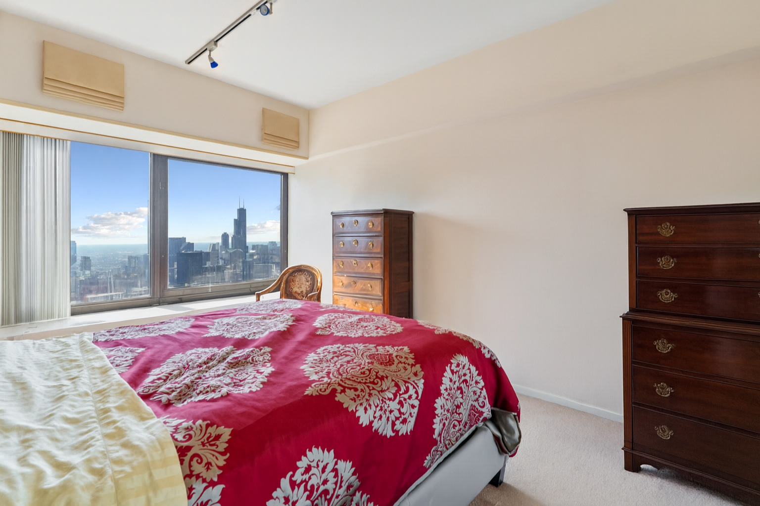 175 East Delaware Place, Unit 7008 Chicago, IL 60611 - Photo 17 of 28 a bed sitting in a bedroom next to a window