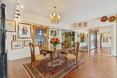 a view of a dining room with furniture and chandelier