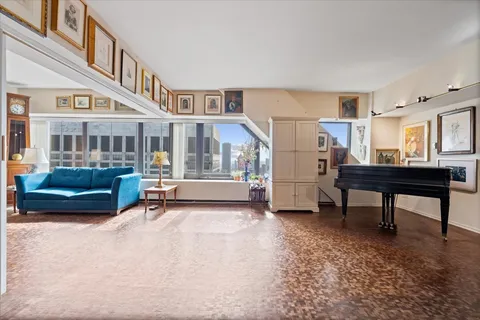 a view of a room with furniture and a window