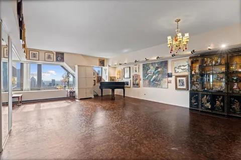 a view of an empty room with furniture and window