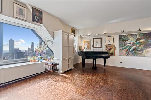 a view of a livingroom with furniture and a window