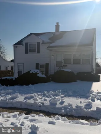 a view of a house with a snow in the yard