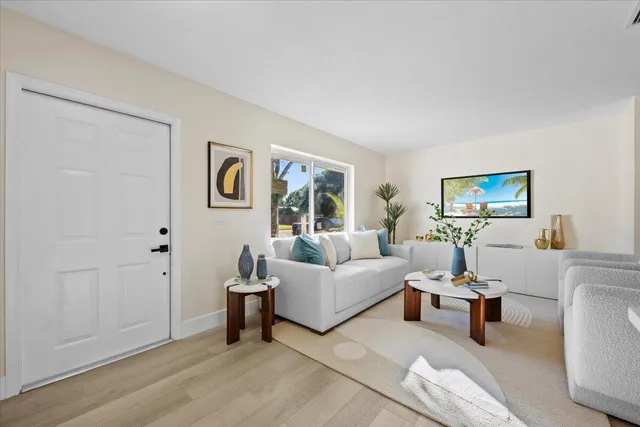 a view of a house with a yard and palm tree