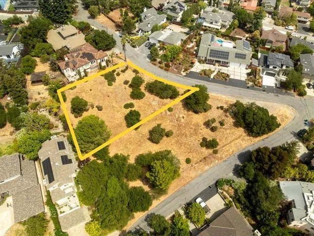 an aerial view of residential houses with yard