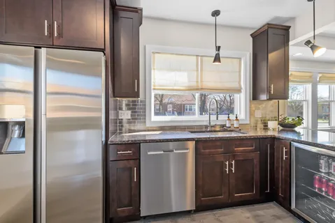a kitchen with a sink a refrigerator and window