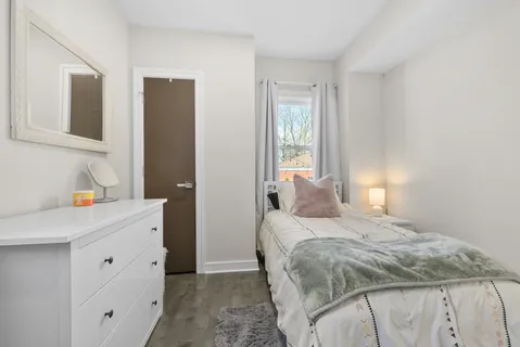 a bedroom with a bed and a window
