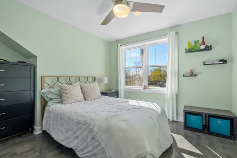 a bed sitting in a bedroom next to a window