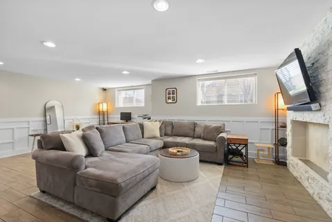 a living room with furniture a fireplace and a flat screen tv