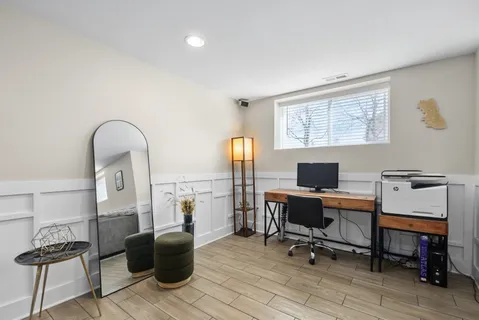 a view of a workspace with furniture and a window