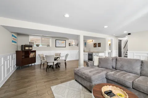 a living room with furniture dining table and a wooden floor