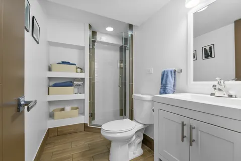 a bathroom with a sink toilet and shower
